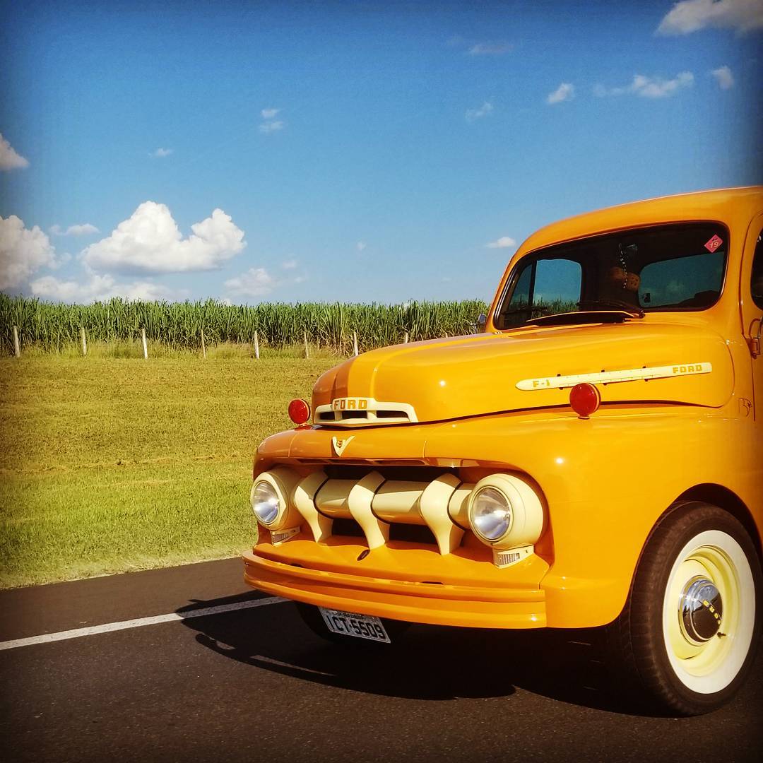 Vintage Yellow Truck against a blue sky.